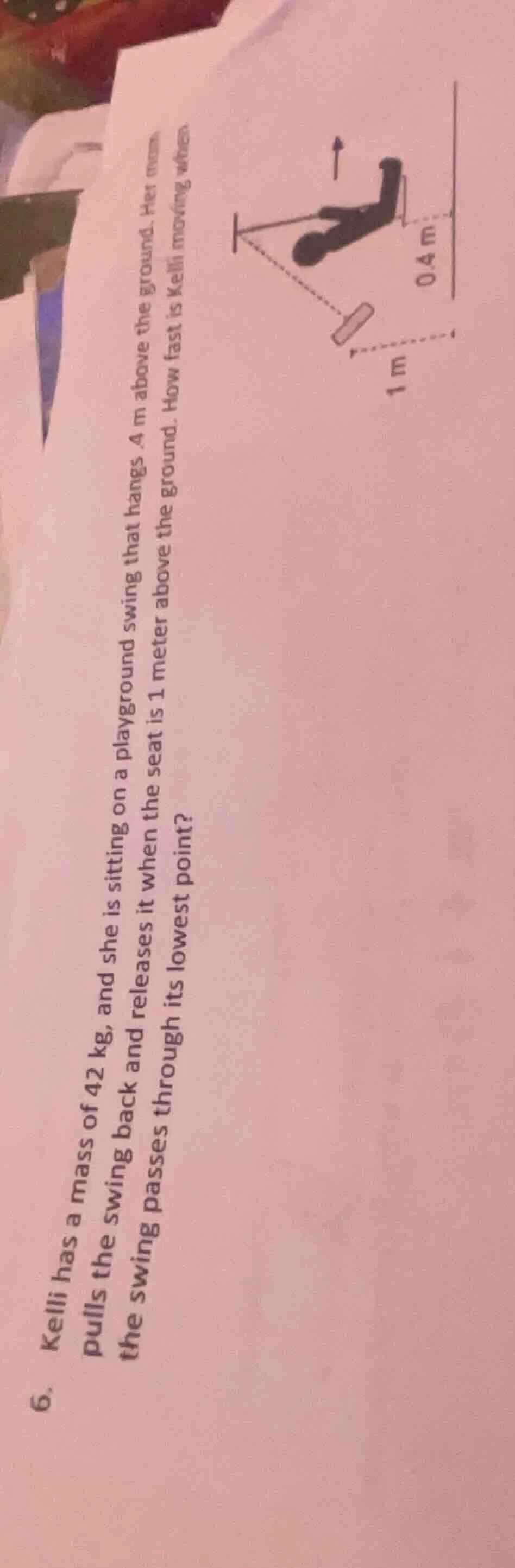 kelli has a mass of 42 kg, and she is sitting on a playground swing tha…