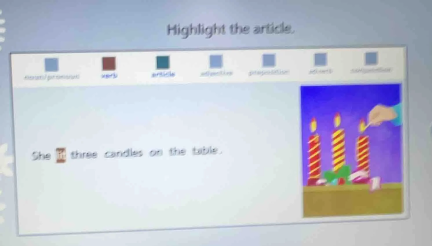 highlight the article. she lit three candles on the table.
