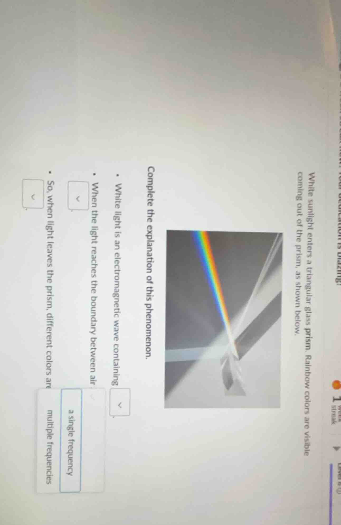 white sunlight enters a triangular glass prism. rainbow colors are visi…