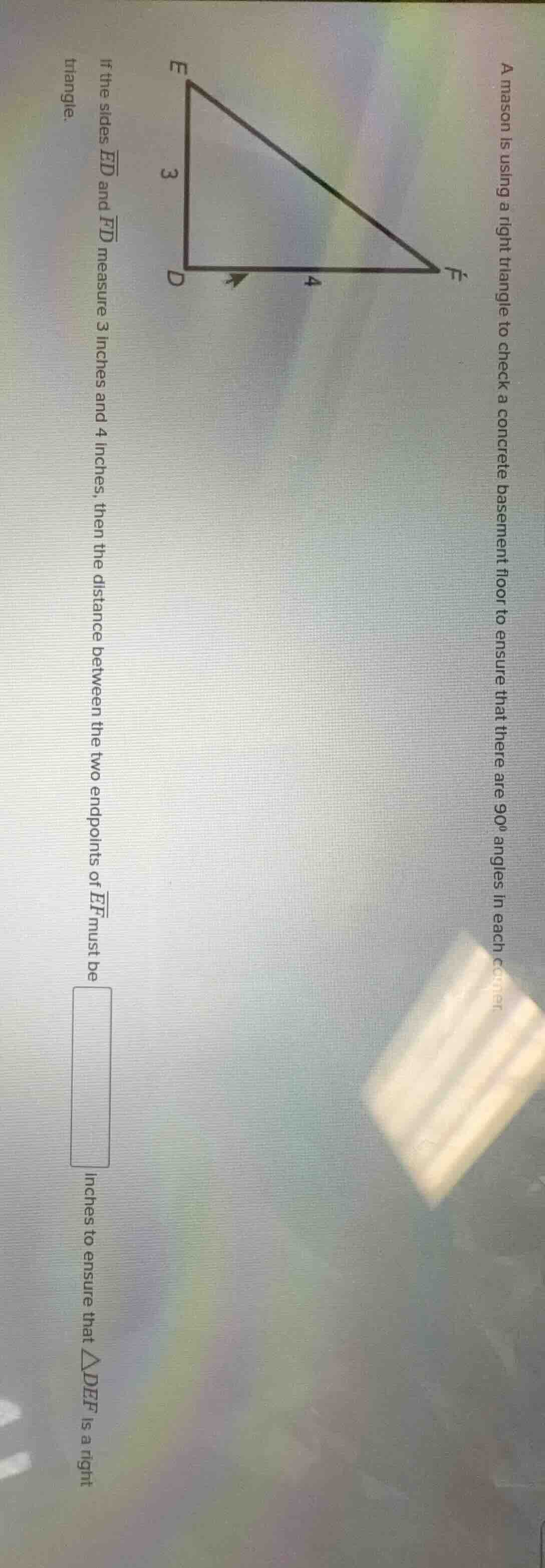 a mason is using a right triangle to check a concrete basement floor to…