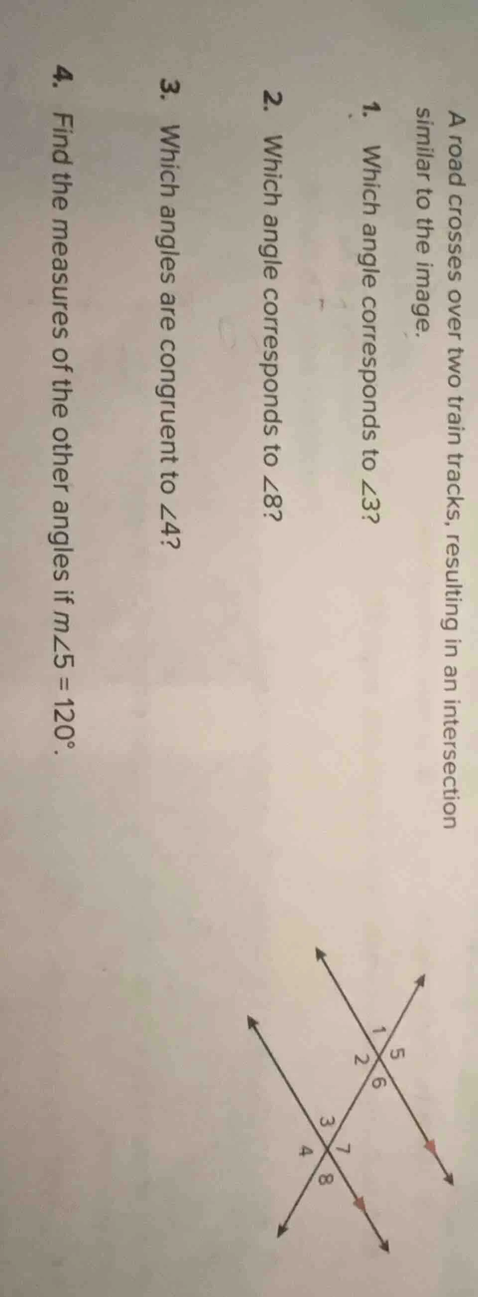 a road crosses over two train tracks, resulting in an intersection simi…