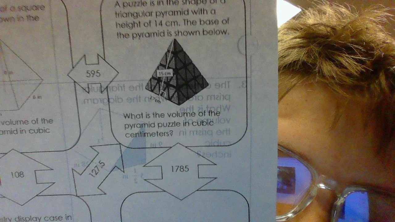 a puzzle is in the shape of a triangular pyramid with a height of 14 cm…