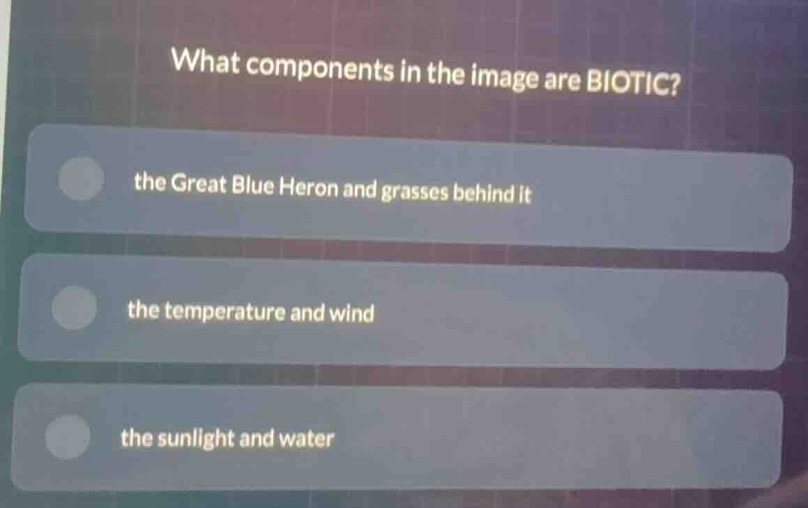 what components in the image are biotic? the great blue heron and grass…